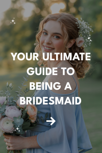 Young woman in a light blue dress smiles as a bridesmaid, surrounded by a lush landscape.