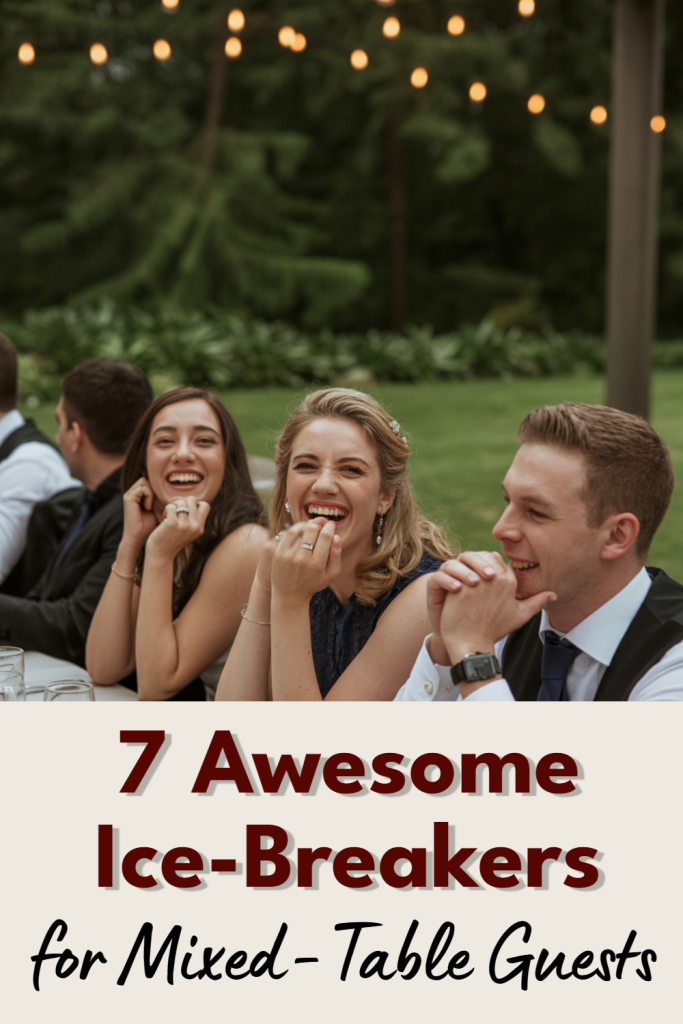 Outdoor wedding reception with guests enjoying laughter and conversation under string lights.