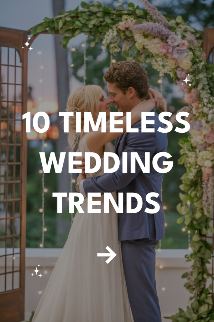 Couple under floral arch celebrating wedding, showcasing timeless trends and romantic ambiance.