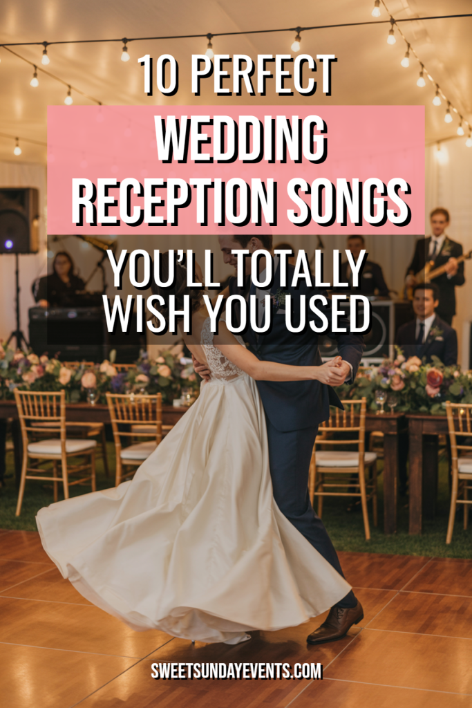 Couple dancing joyfully at a romantic wedding reception with elegant decor and live music.