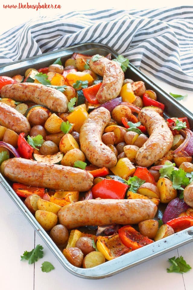 Italian sausage in sheet pan cooked with tomatoes, potatoes, bell peppers and onion.