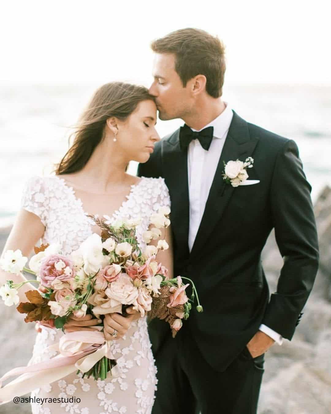 The Groom Kisses Bride's Forehead Tenderly
