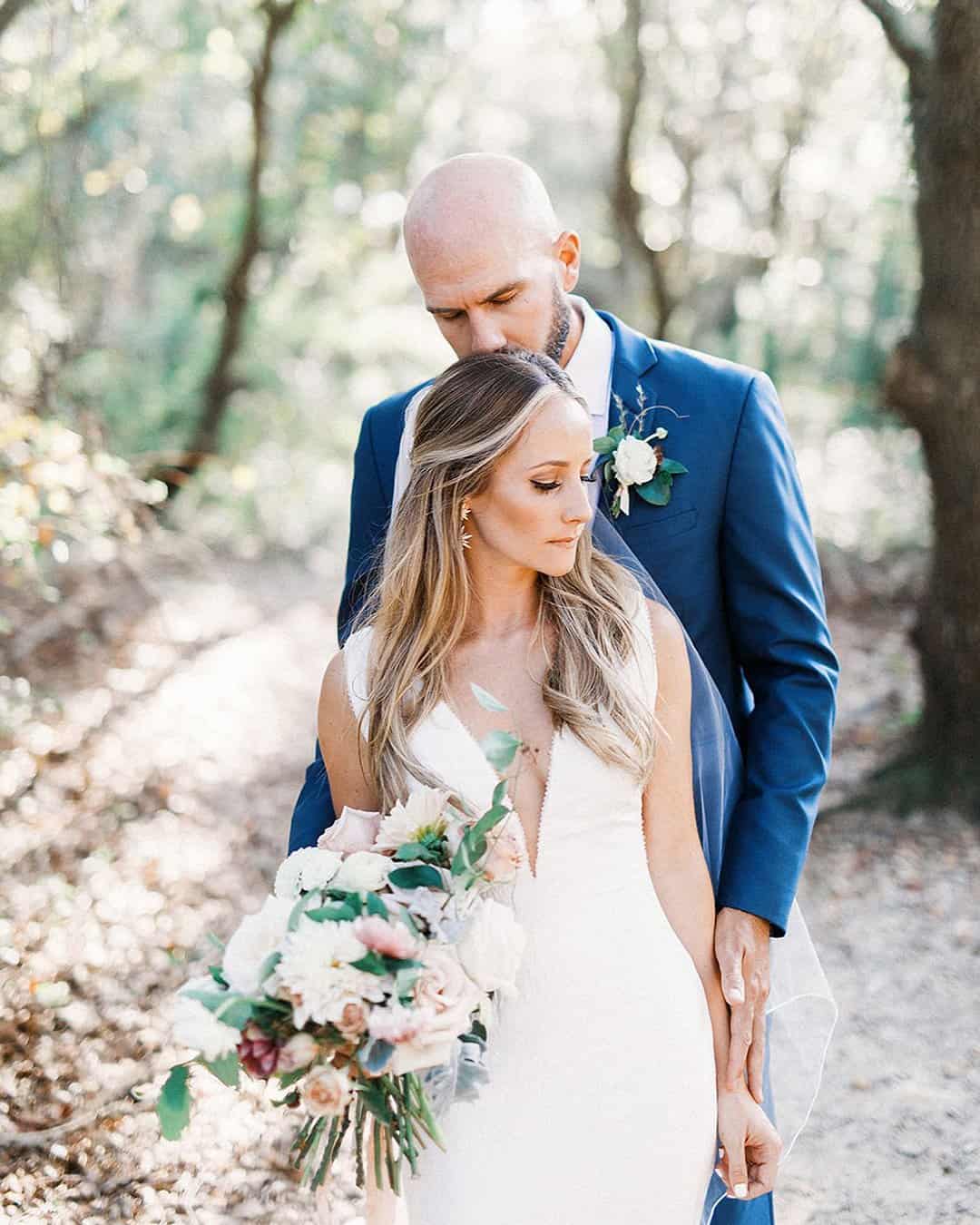 The Groom Kisses Bride's Forehead Tenderly