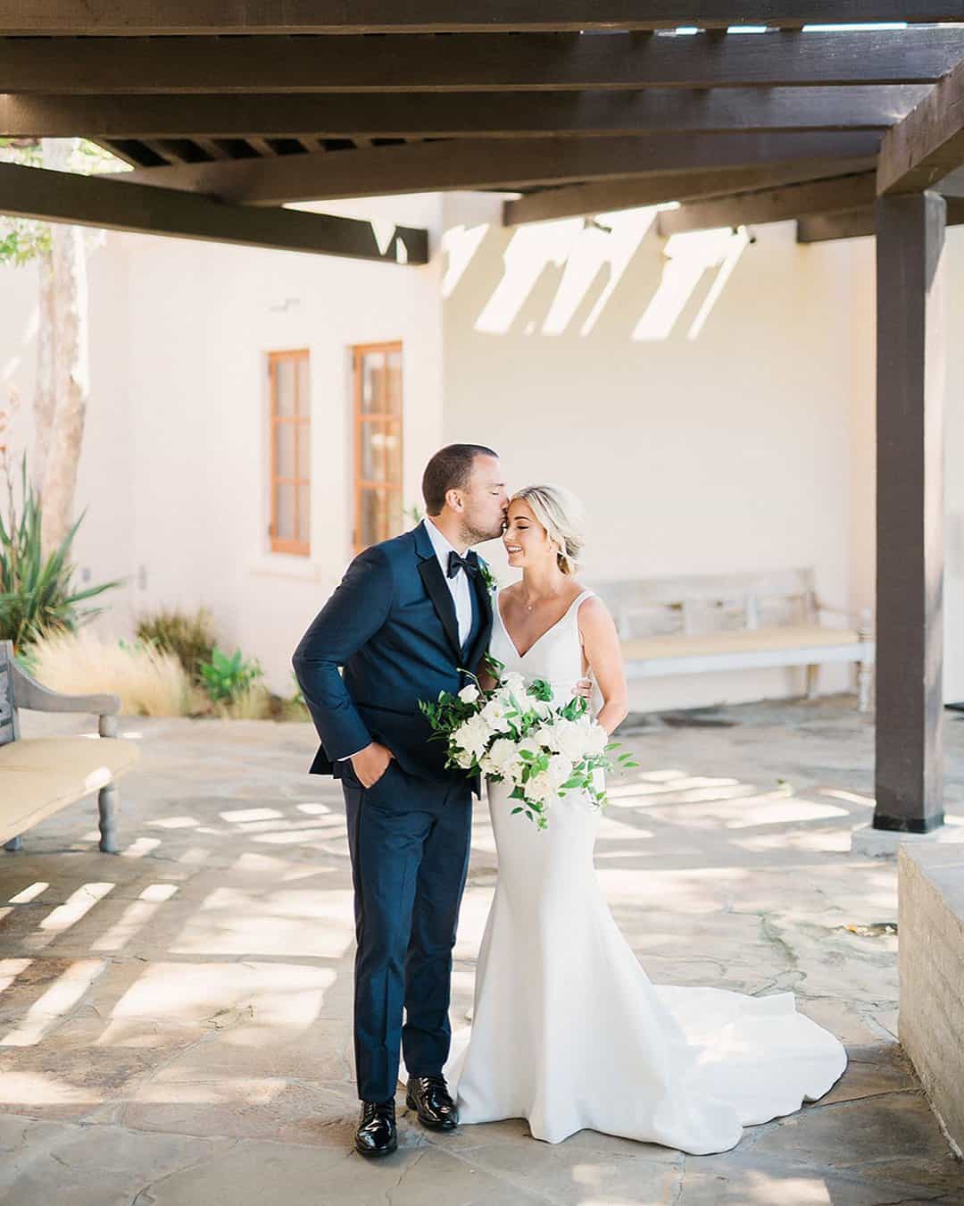 The Groom Kisses Bride's Forehead Tenderly