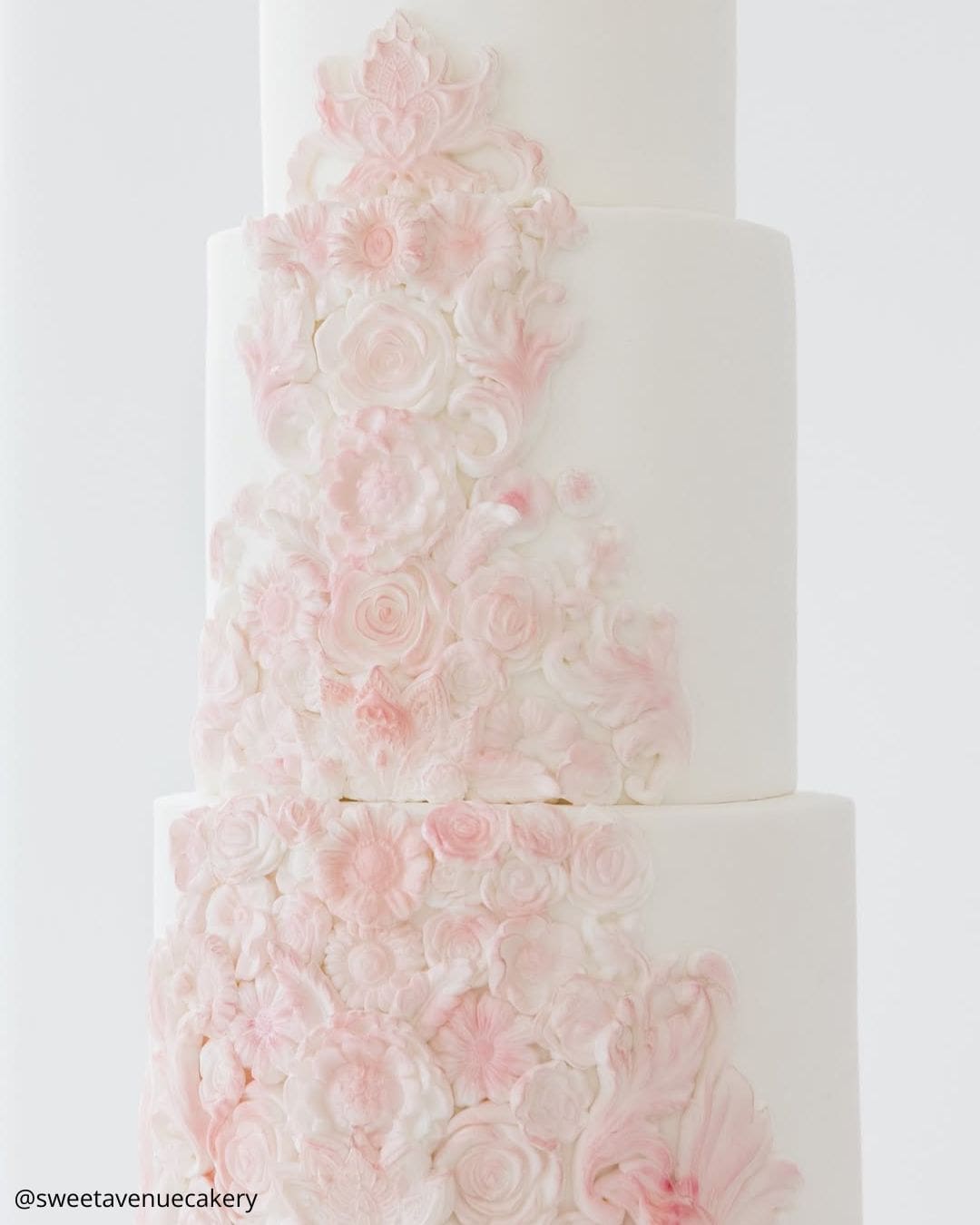 unique wedding cakes white cake with intricate pink floral bas relief sweetavenuecakery