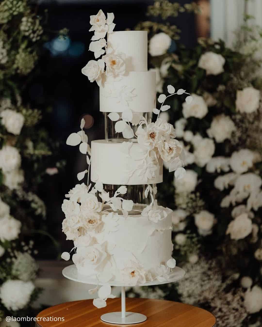 unique wedding cakes tall white tiered cake with clear spacers and cascading white roses laombrecreations
