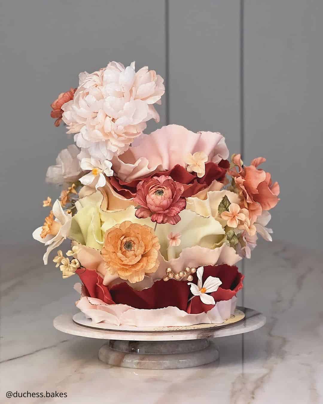unique wedding cakes elegant ruffle cake with rich autumn floral decor duchess.bakes