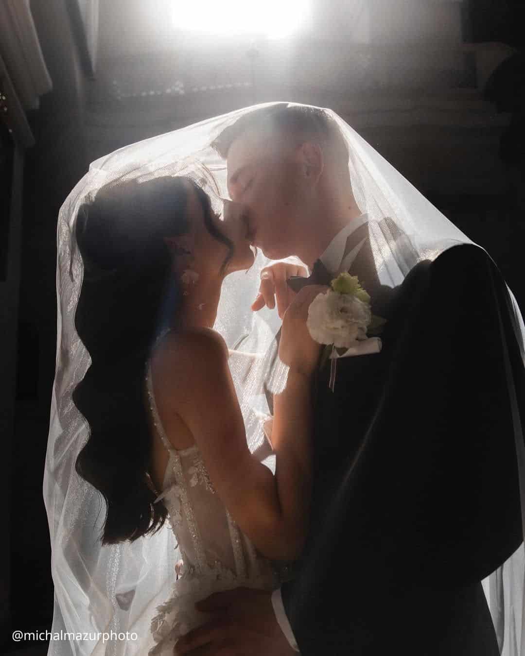 wedding photos kiss of the happy brides under the veil michalmazurphoto
