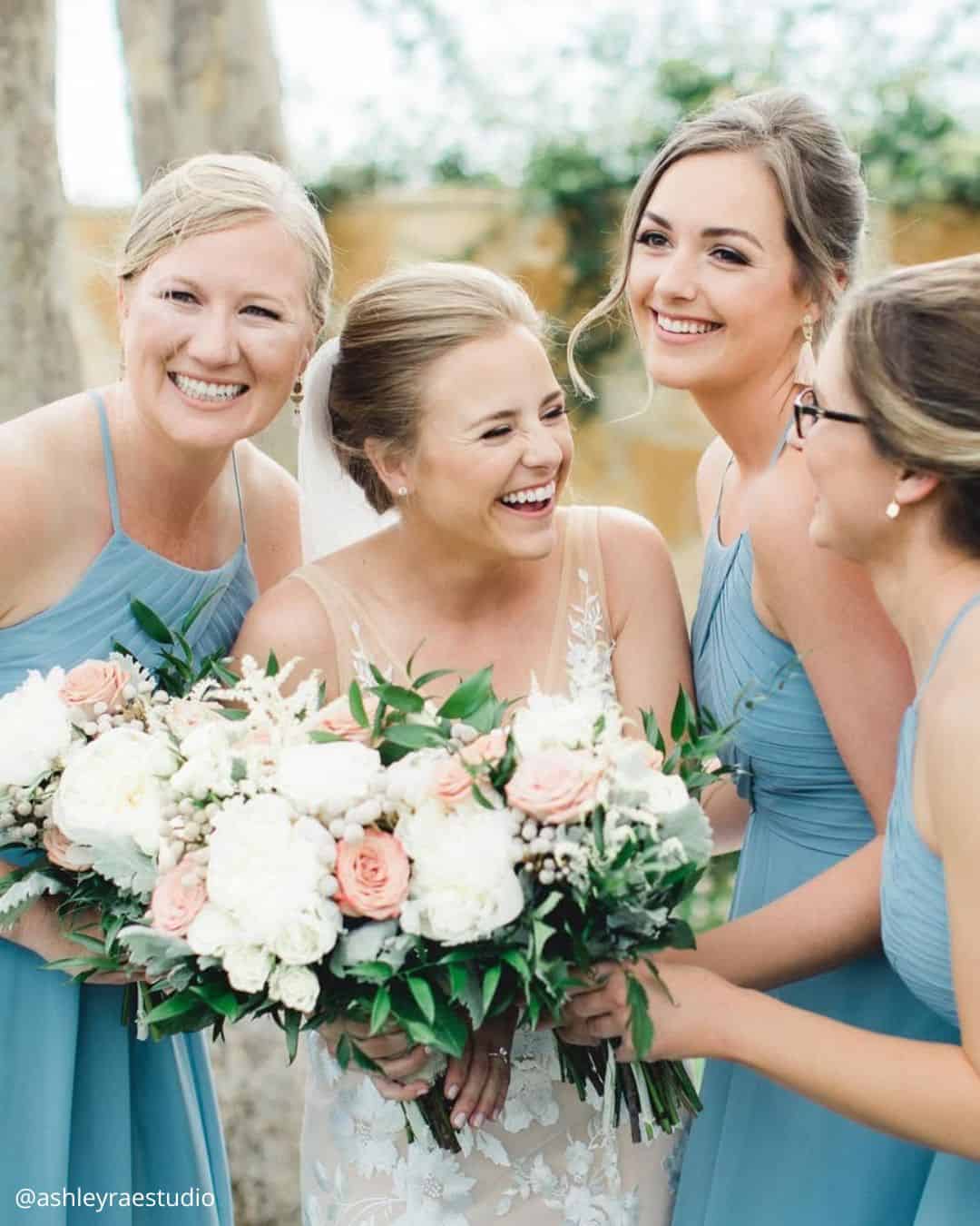 wedding photos bride with friends holding a bouquet happy smiling ashleyraestudio