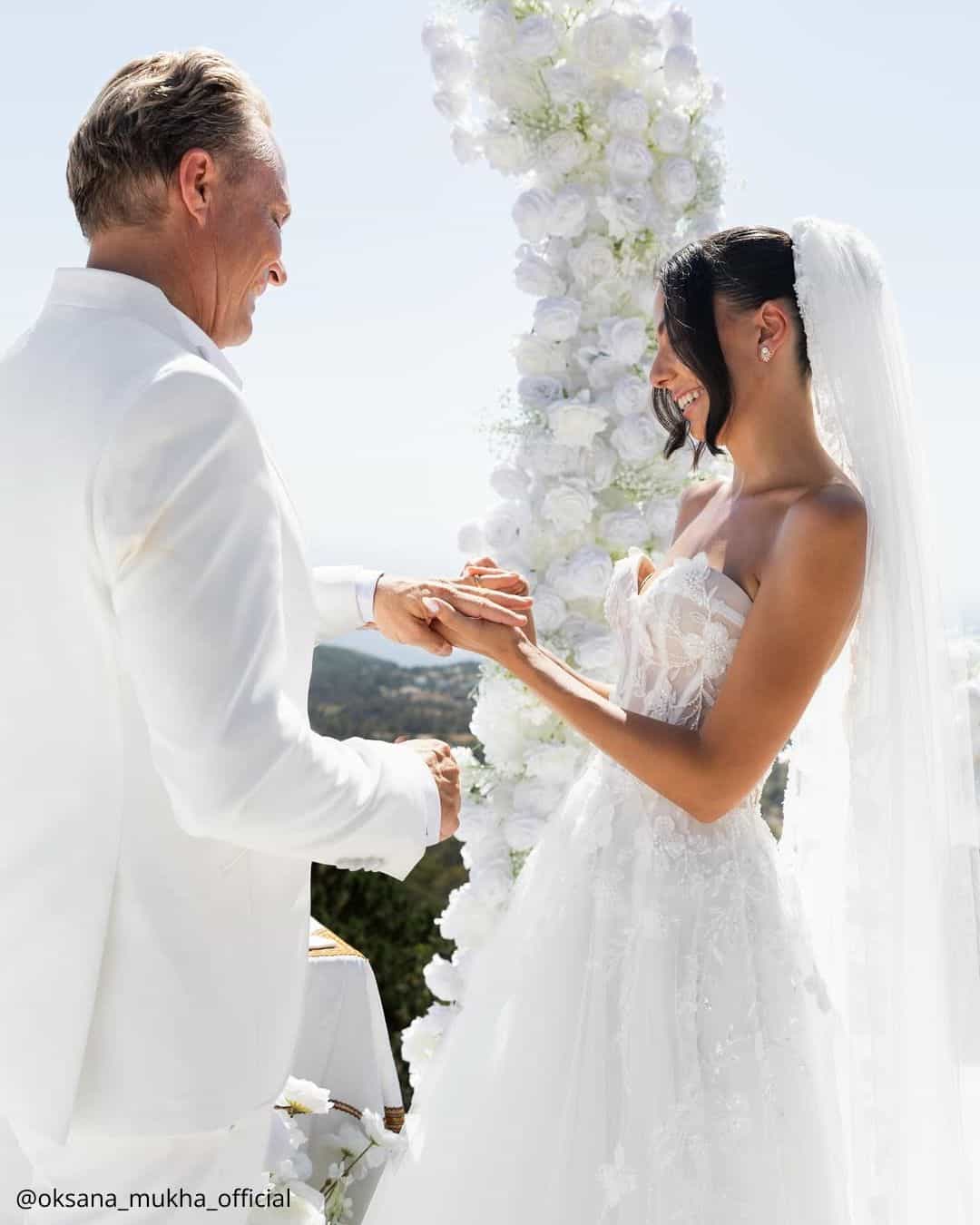 wedding photos happy brides at the ceremony wearing rings white arch oksana mukha official