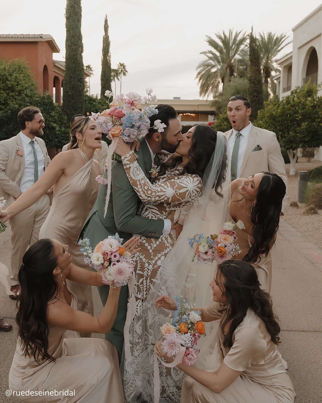 wedding photos brides kissing with fun friends all with a bouquet in hands ruedeseinebridal